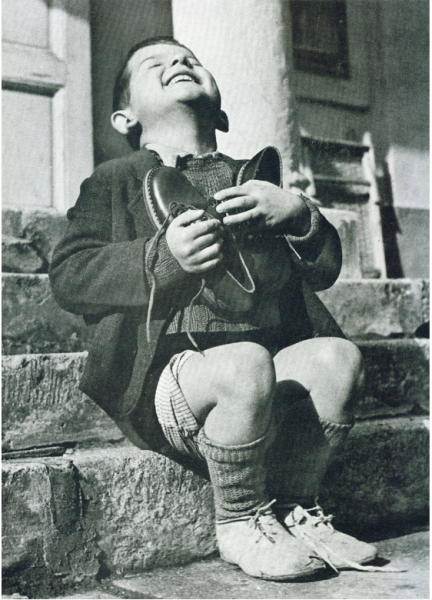 Image source: Gerald Waller
Austrian Boy Receives New Shoes During WWII